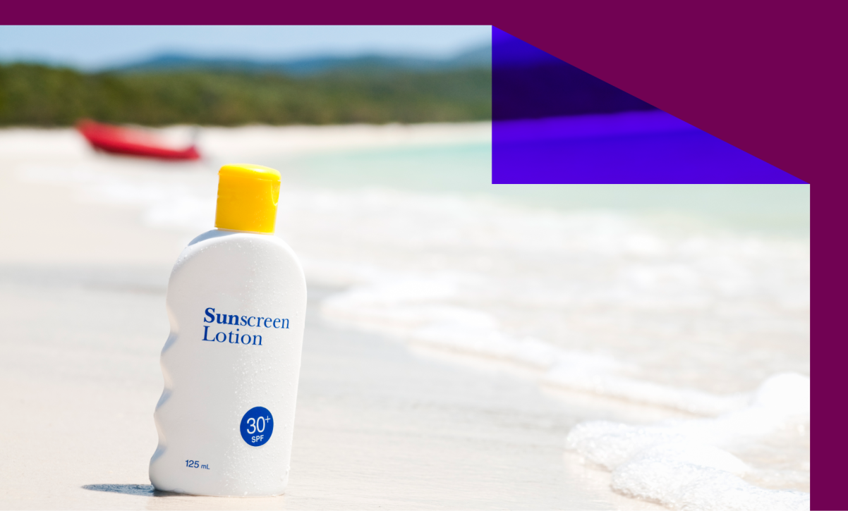 A bottle of sunscreen lotion on an idyllic tropical beach.