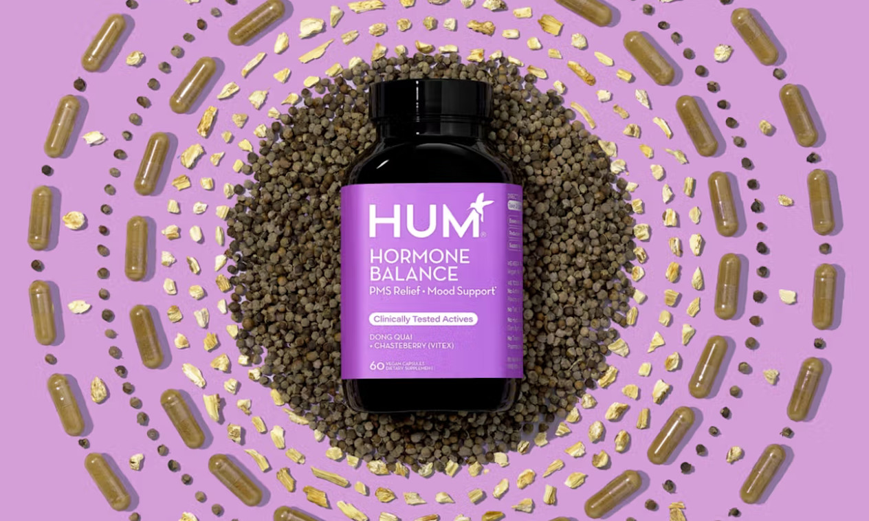 Brown glass bottle with purple layering surrounding by circles of supplements and herbs on purple background