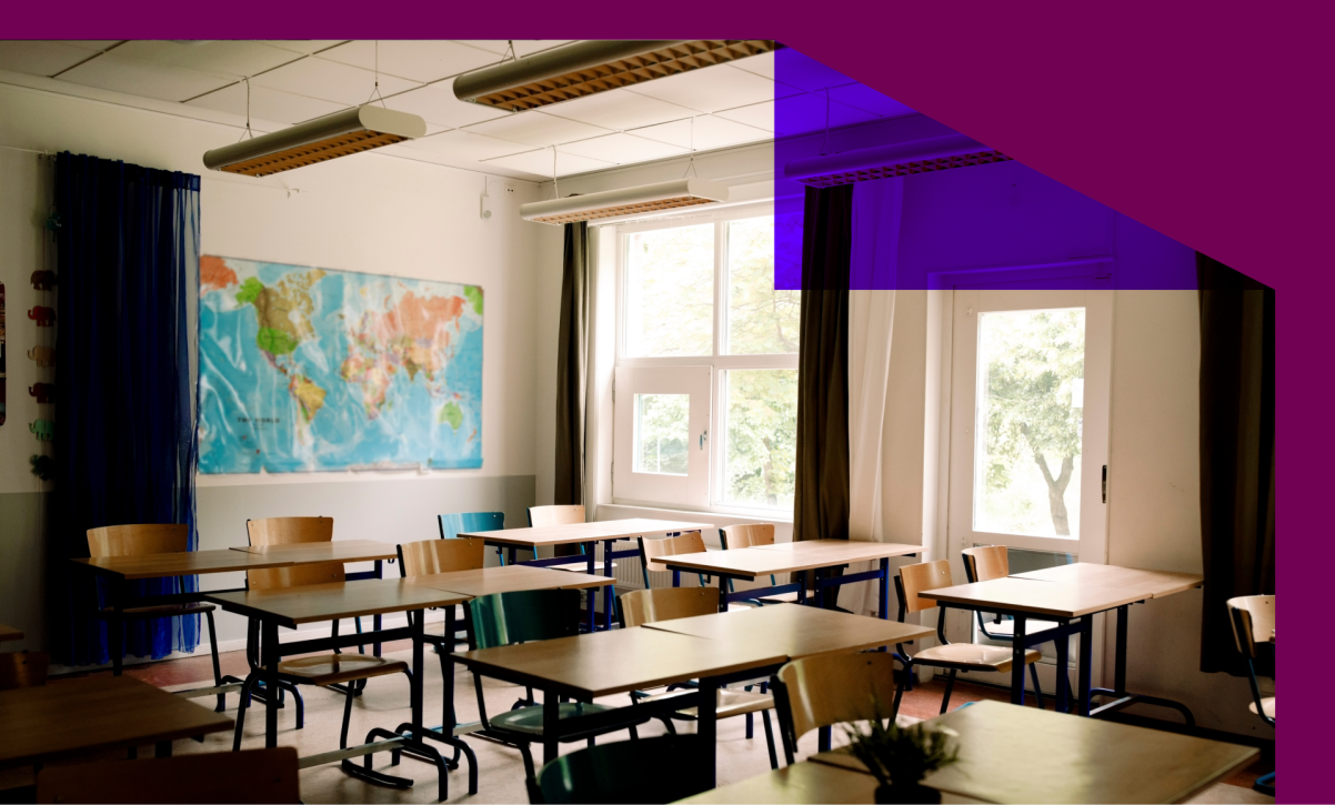 Desks and chairs arranged in classroom at high school - stock photo