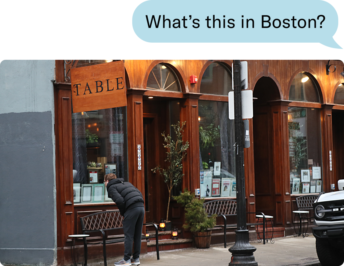 Woman looking into Table restaurant in Boston, MA.